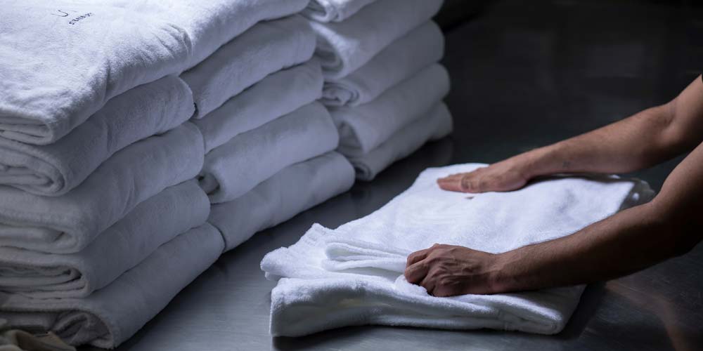 Folding white clean towels.