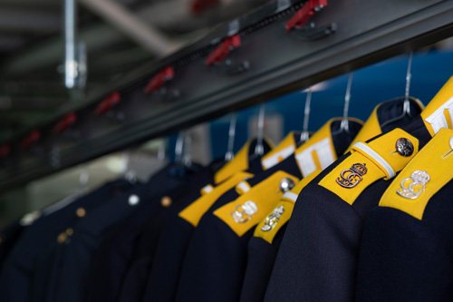 Uniforms with insignias that have been cleaned.