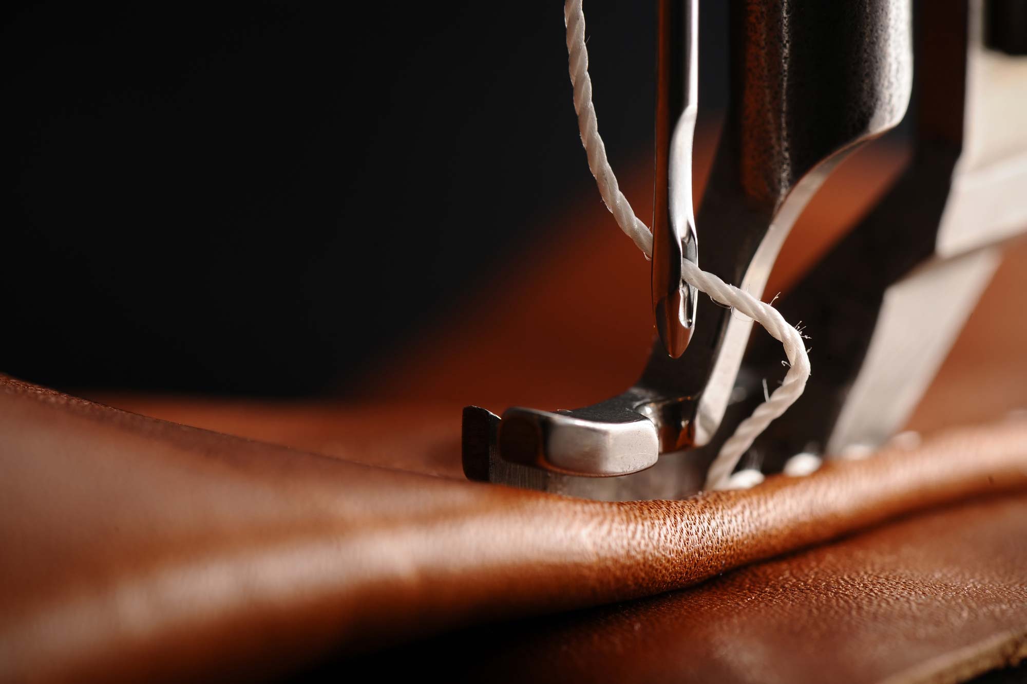 Machine sewing through leather.